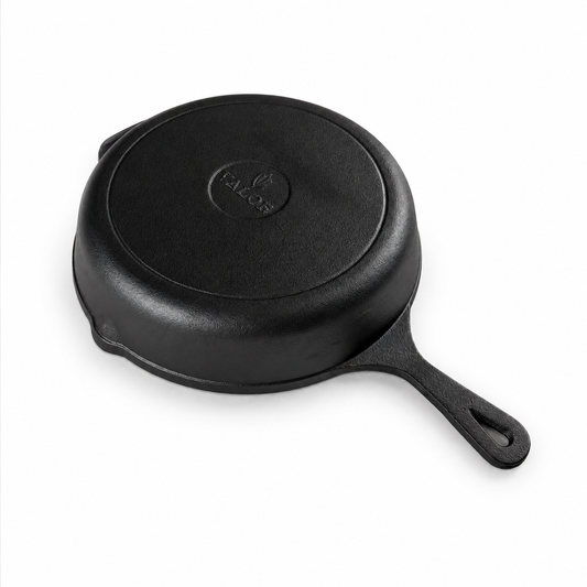 Bottom view of a Valor 10.25-inch pre-seasoned cast iron skillet, showing its flat base, long handle, and helper handle.Distribution